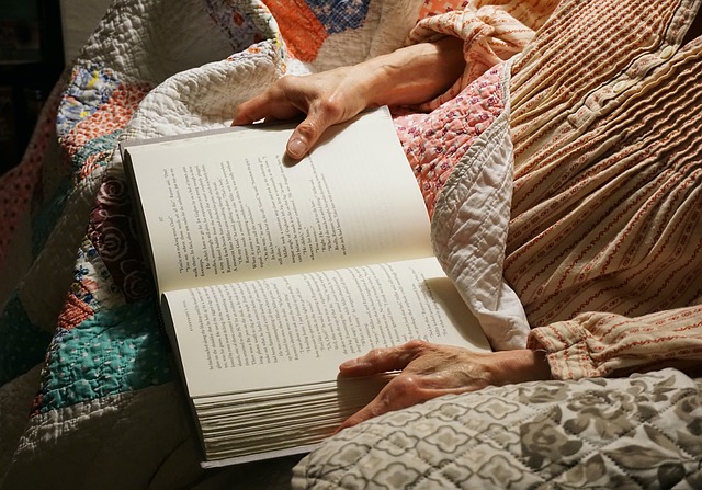 person-in-bed-reading-book