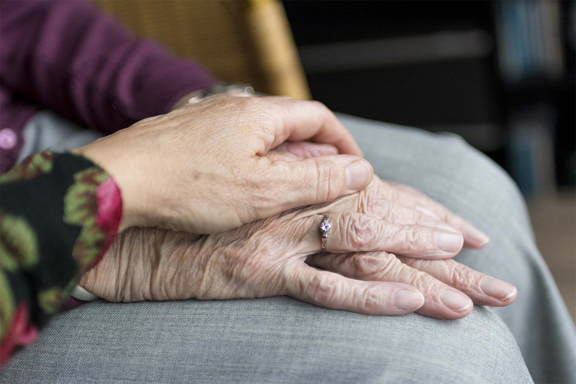 Resident holding hands