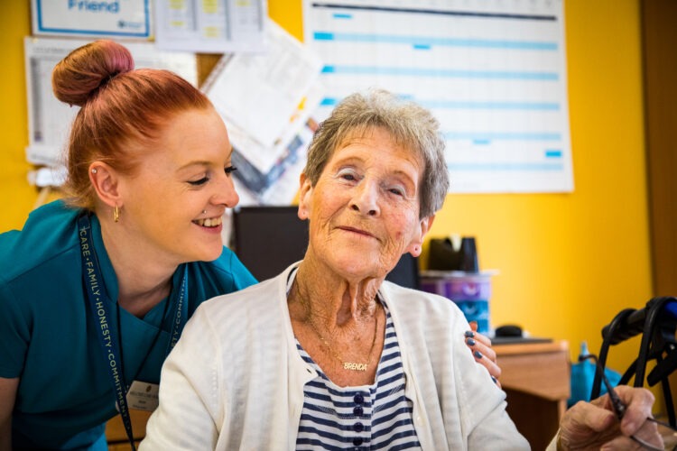resident smiling with carer 