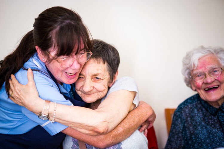 resident smiling with carer 