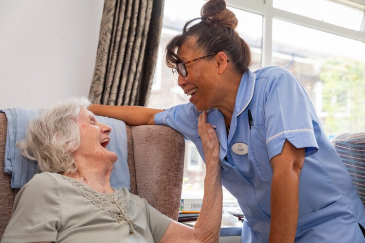 resident laughing with carer