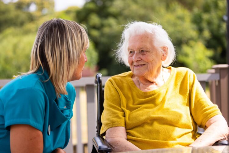 resident smiling with carer 